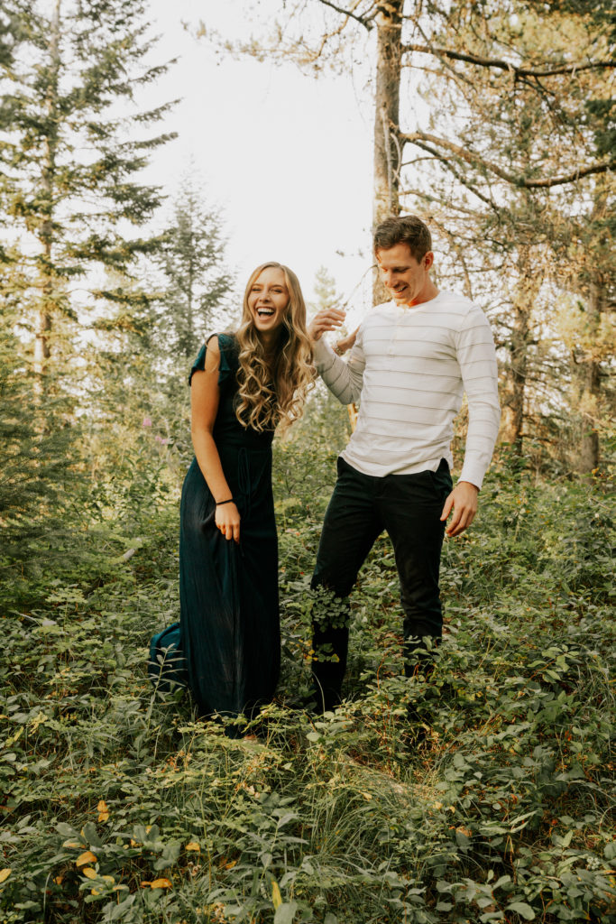man and woman walking through omaha forest during session to make each other feel more comfortable in front of camera