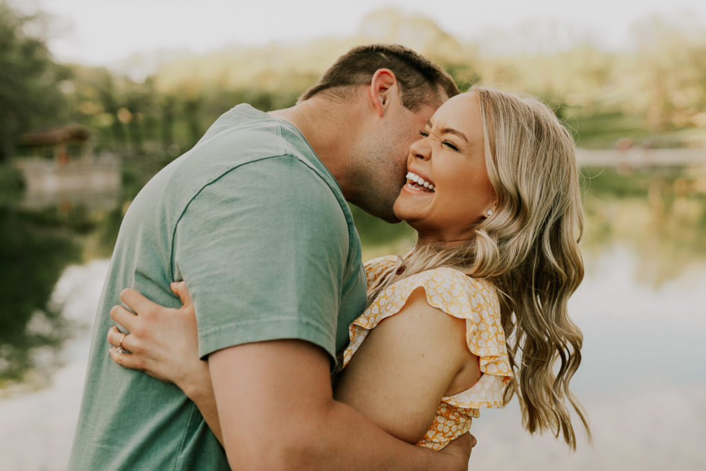man and woman hugging and laughing to get more comfortable in front of camera