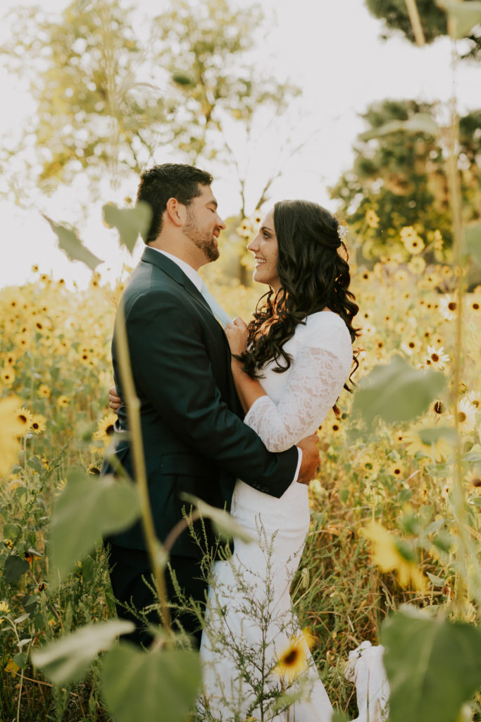 bride and groom in grove of sunflowers during Louisville bridals session
