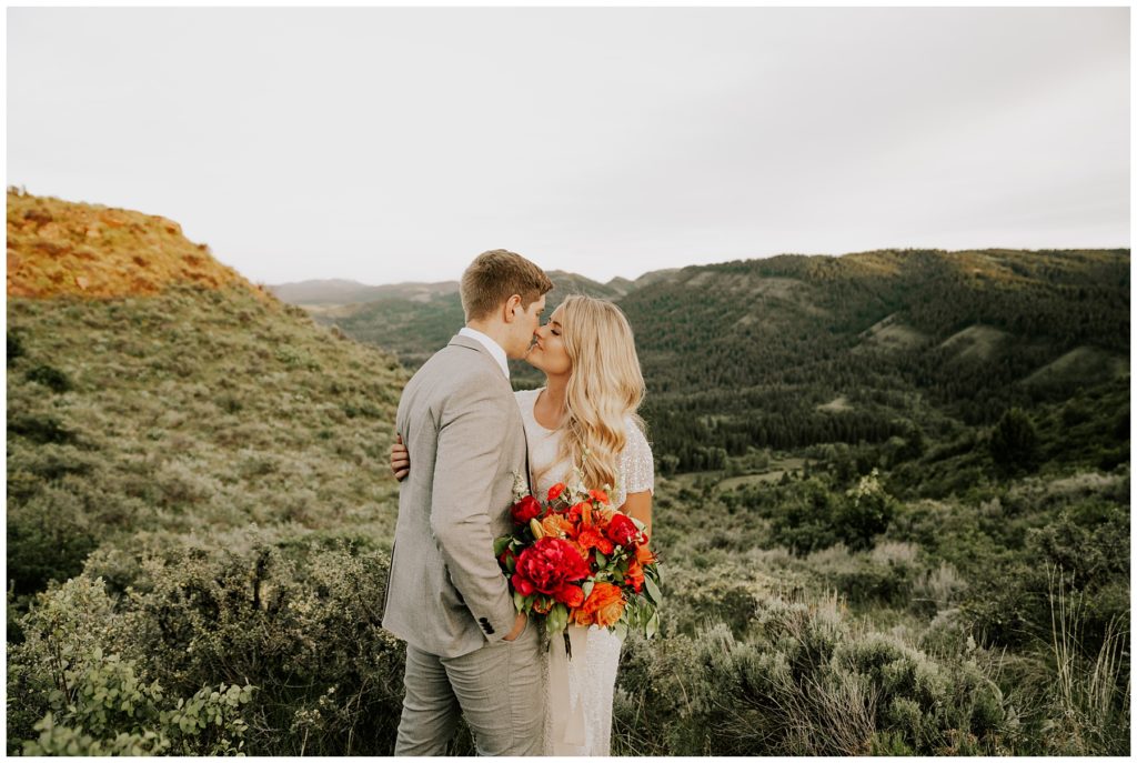 bride and groom kissing during mountainside bridals session in Utah