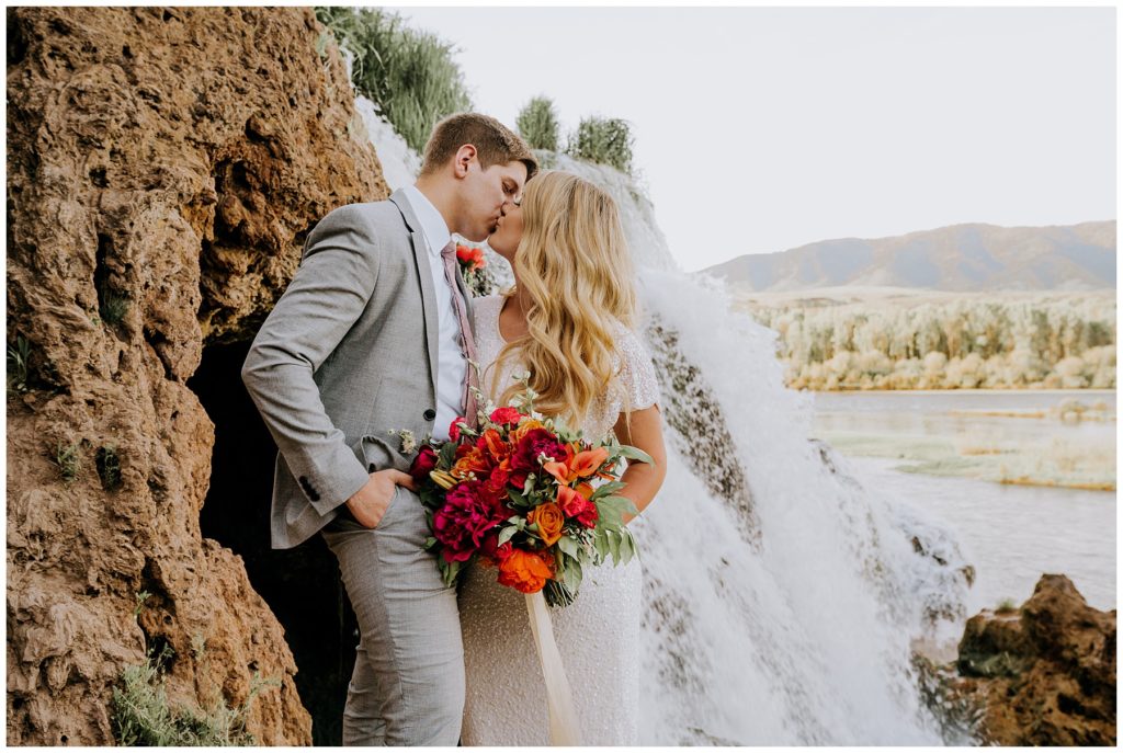 bride and groom kissing during adventure session