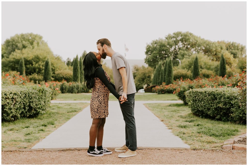 couple kissing in downtown engagement session