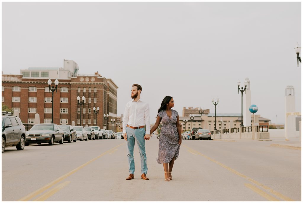 couple standing in city of omaha during engagement session