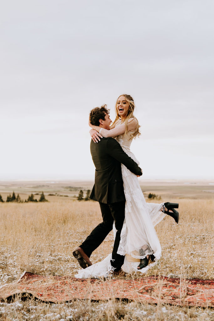 man lifting woman up during bridals session in utah valley