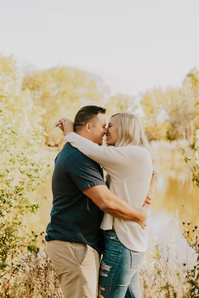 man and woman hugging during outdoor engagement shoot