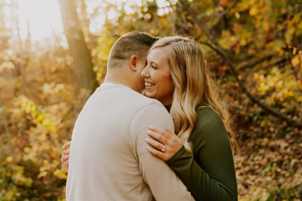 man and woman hugging while woman laughs in Nebraska 