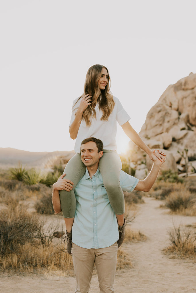 Woman on top of man’s shoulders during couple session in Joshua Tree