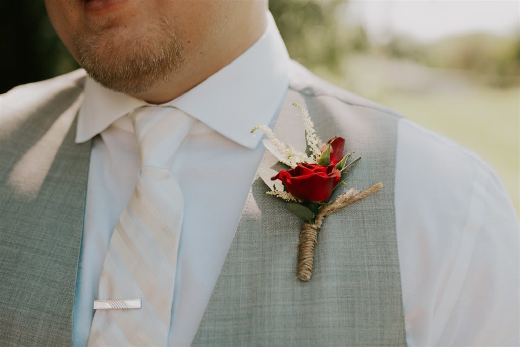 groom's flowers for his vest at backyard wedding