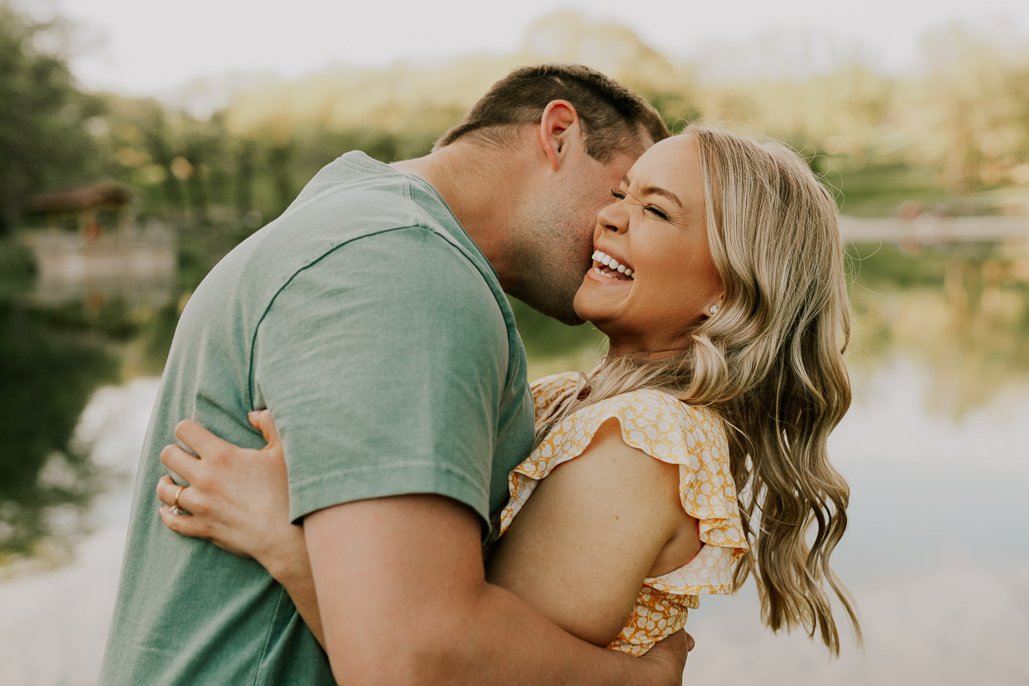 man and woman hugging and laughing to get more comfortable in front of camera