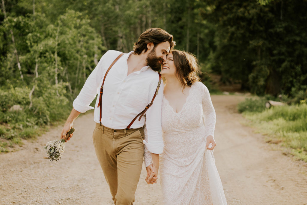bride and groom walking down the streets of jackson hole after adventure elopement