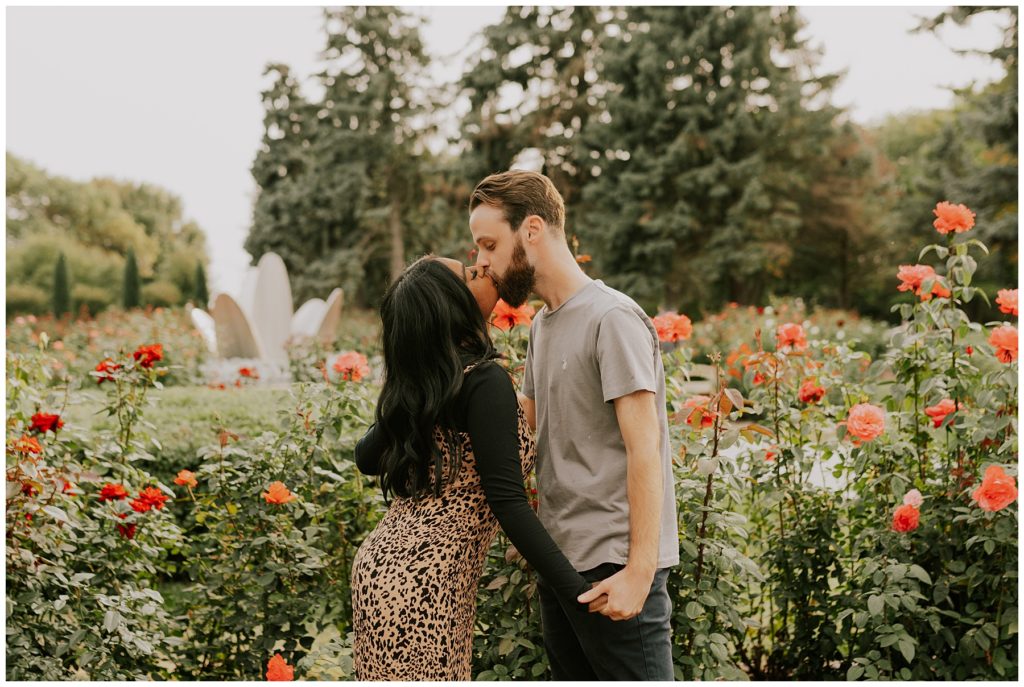 couple kissing in flower field