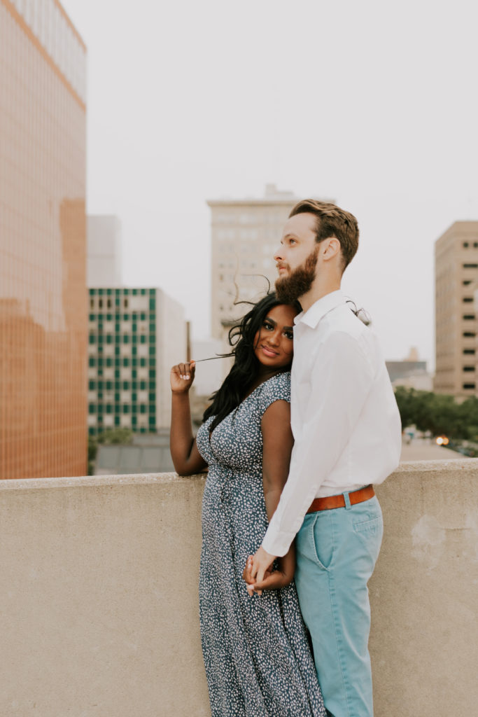man and woman posing together during downtown omaha engagement session