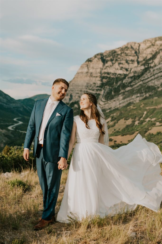 bride and groom posing by mountain in utah valley bridal session