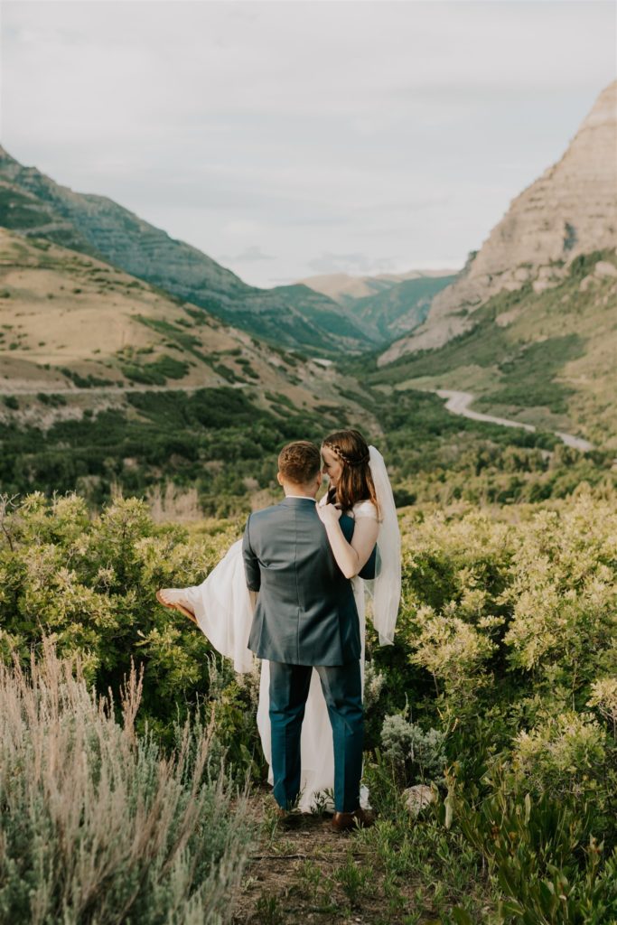 groom carrying bride during bridal session in provo utah 
