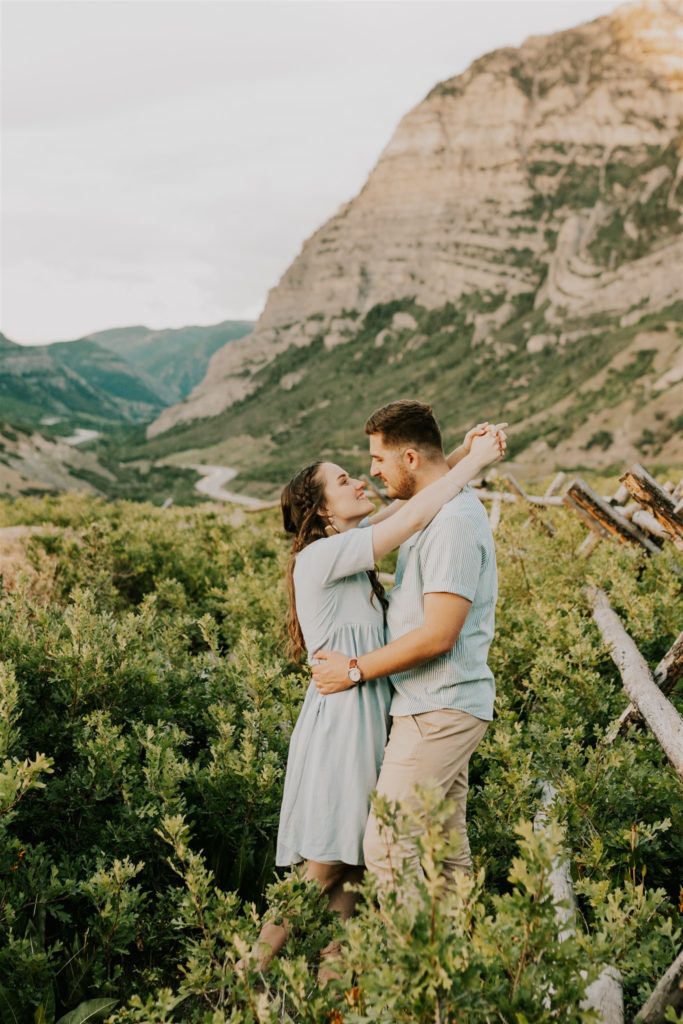couple hugging mountainside in utah anniversary session