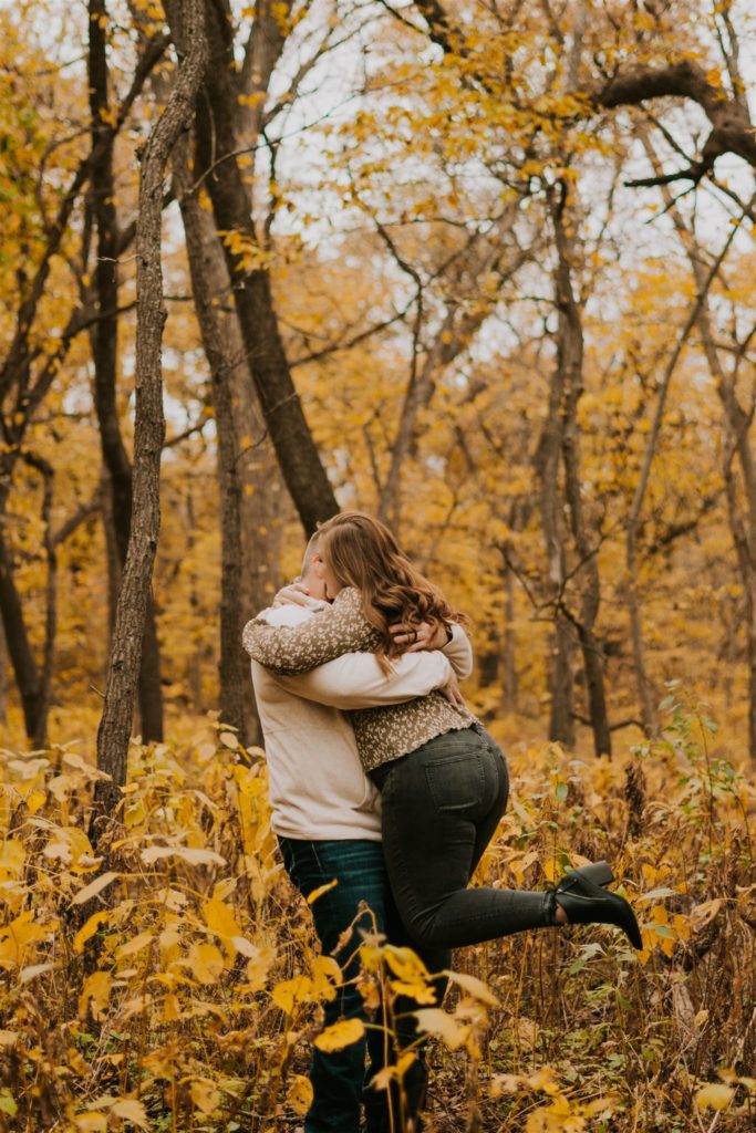 couple getting engaged after proposal in omaha forest