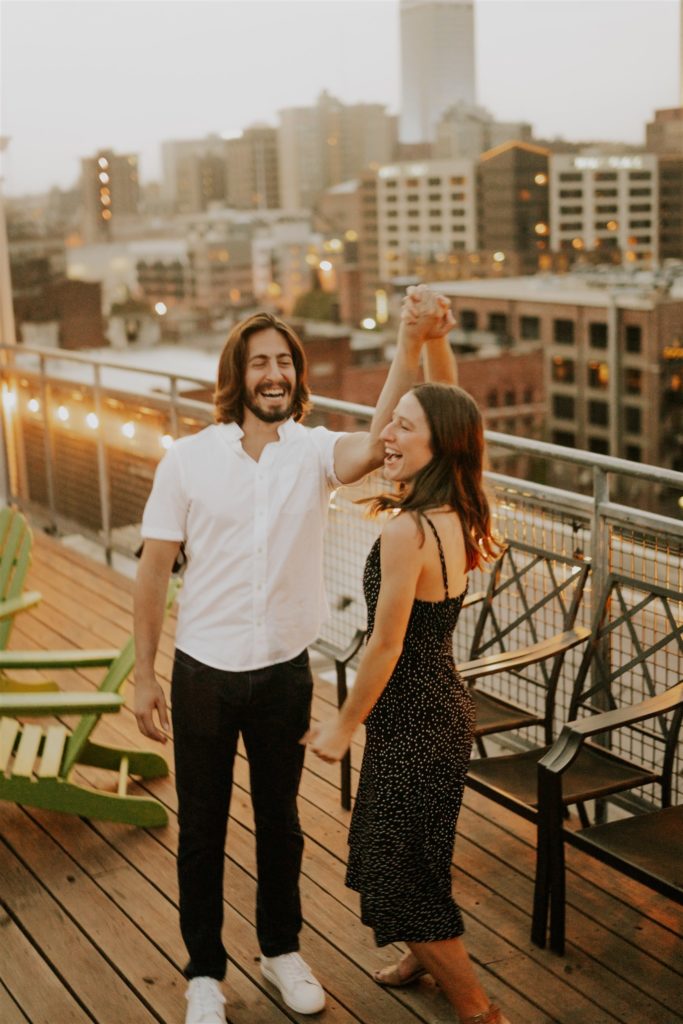couple posing during downtown omaha proposal