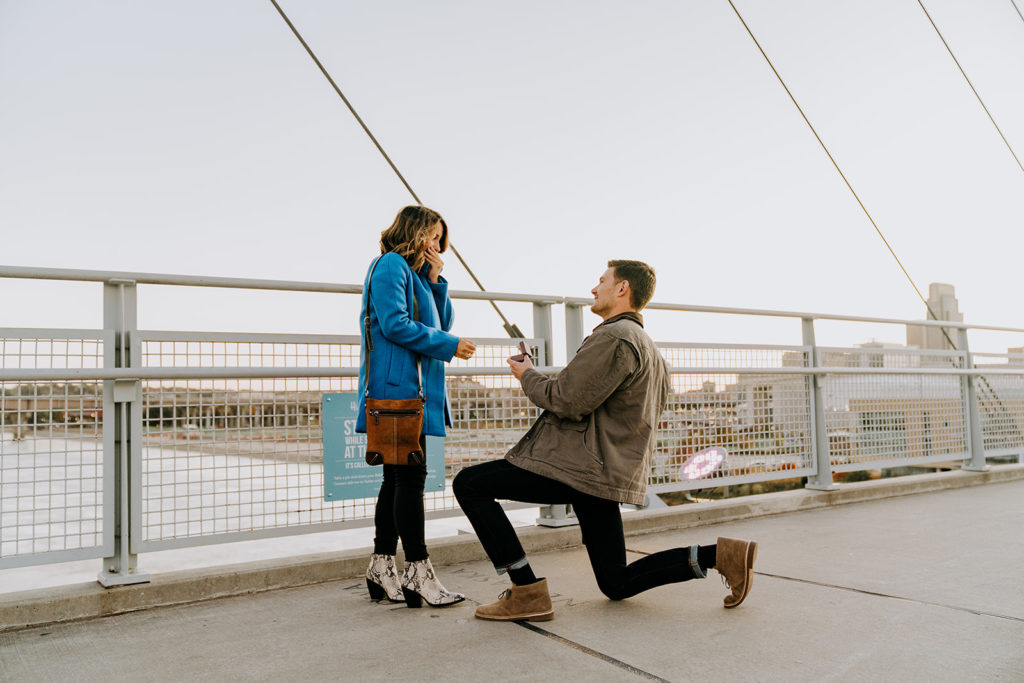 man proposing to girlfriend on pedestrian bridge in omaha