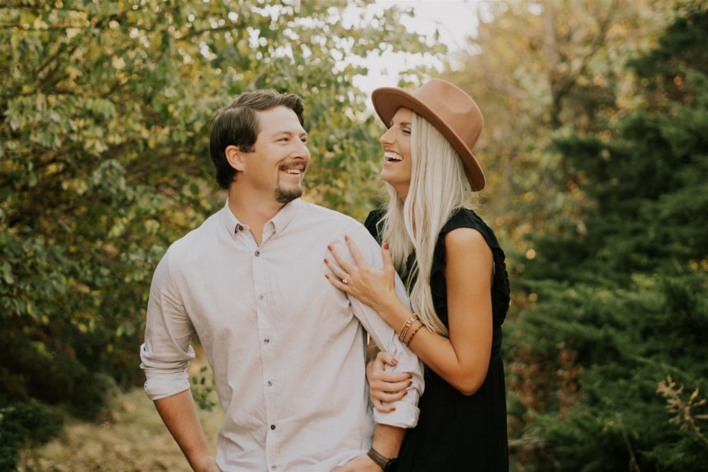 couple posing in omaha forest during engagement session