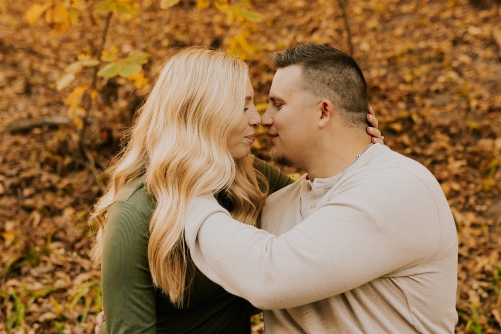 newly engaged couple kissing during outdoor engagement session in Gretna nebraska