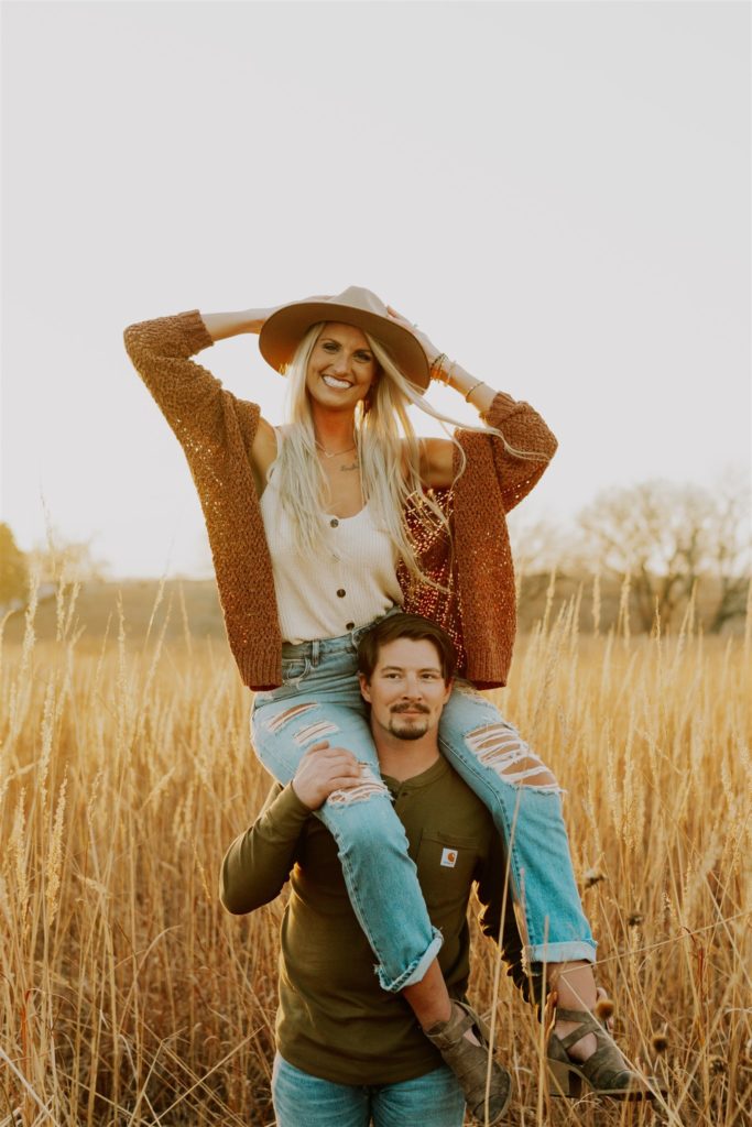 woman on top of man's shoulders during engagement session