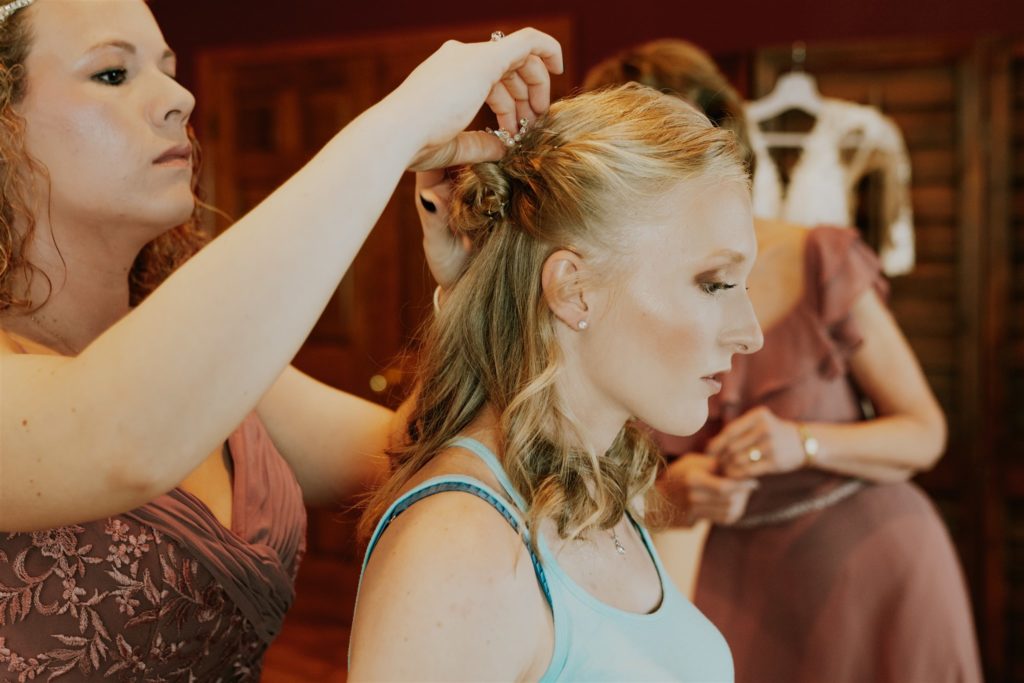 woman getting hair and makeup done before wedding getting memorable getting ready pictures