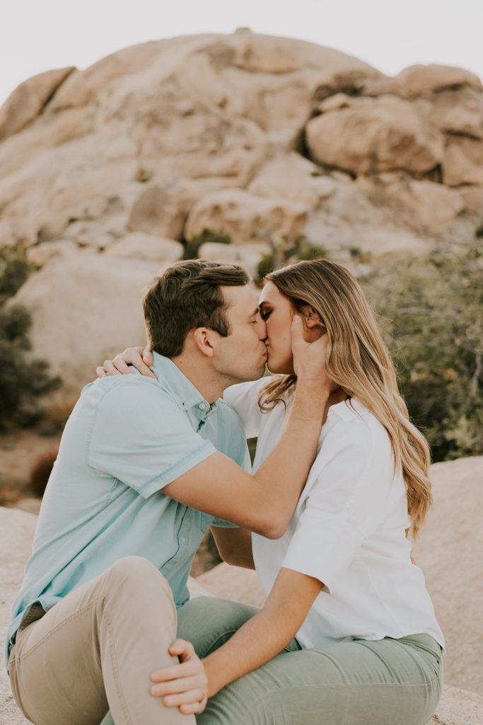 Man and woman kissing in Joshua tree couple session