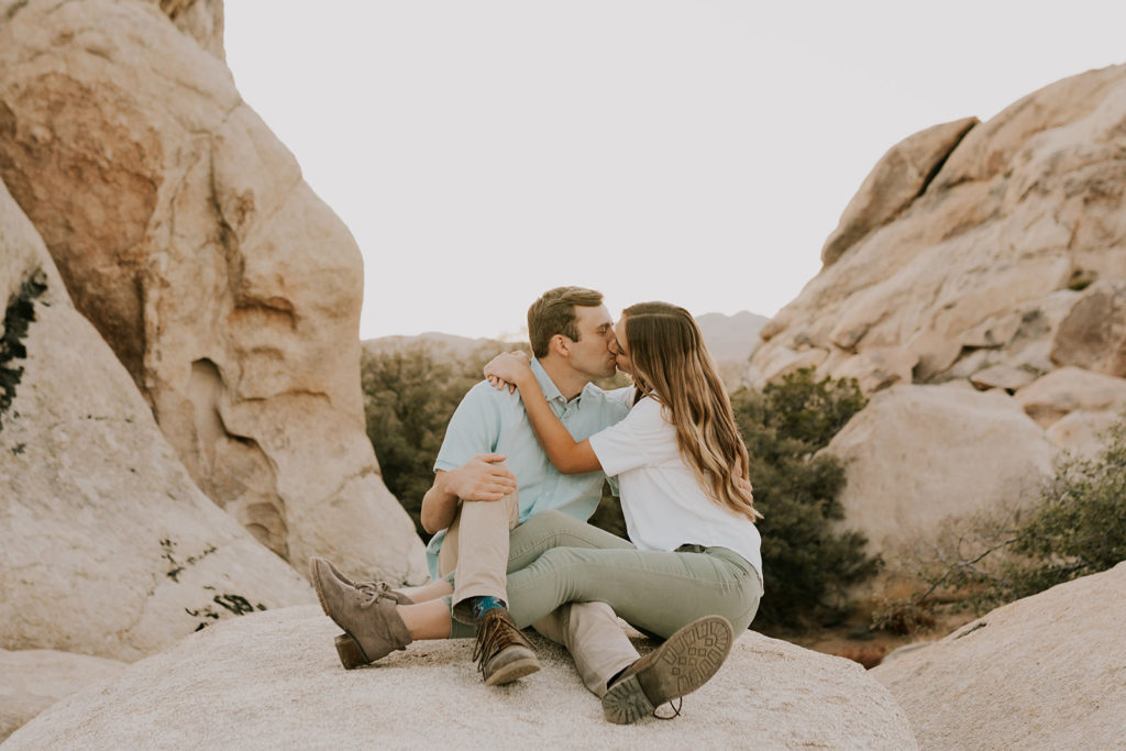 Couple kissing on boulder 